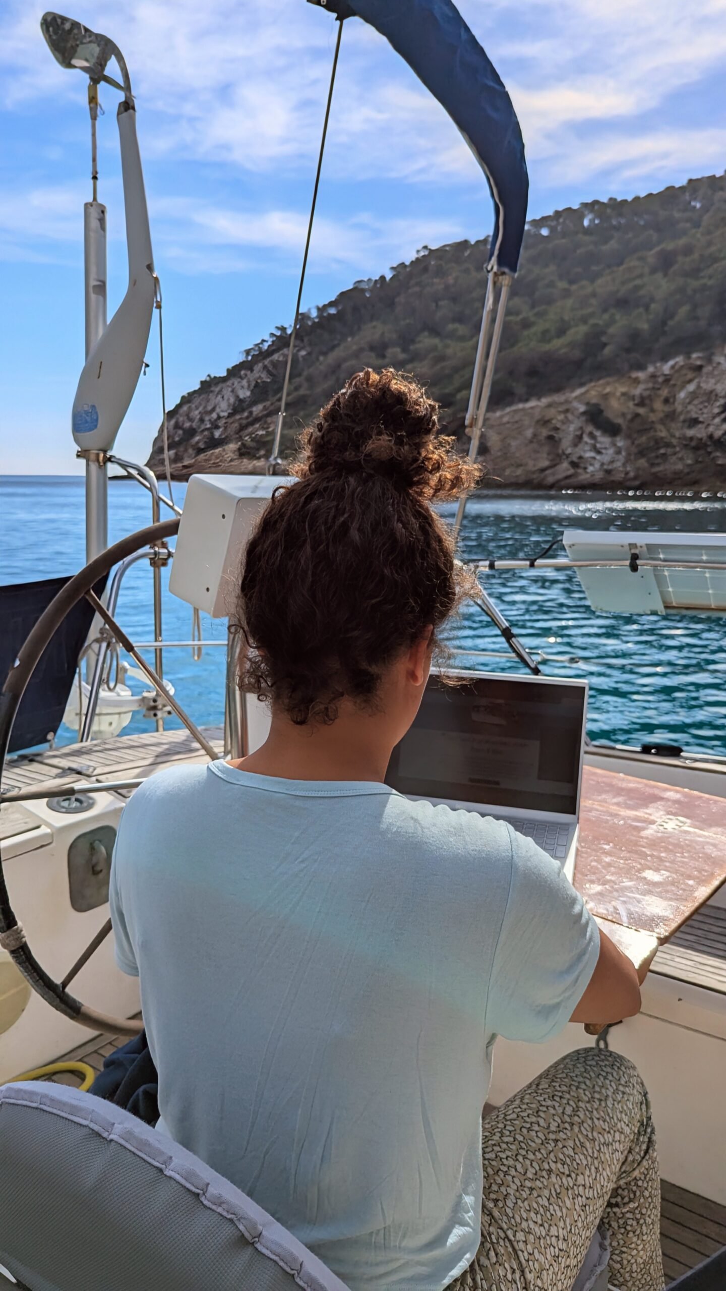 bel working outide on laptop on web design and seo on ibiza